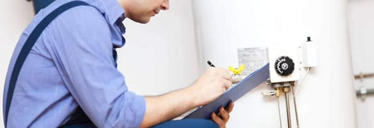 Water heater repair technician inspecting the unit and recording service notes in Sacramento, CA